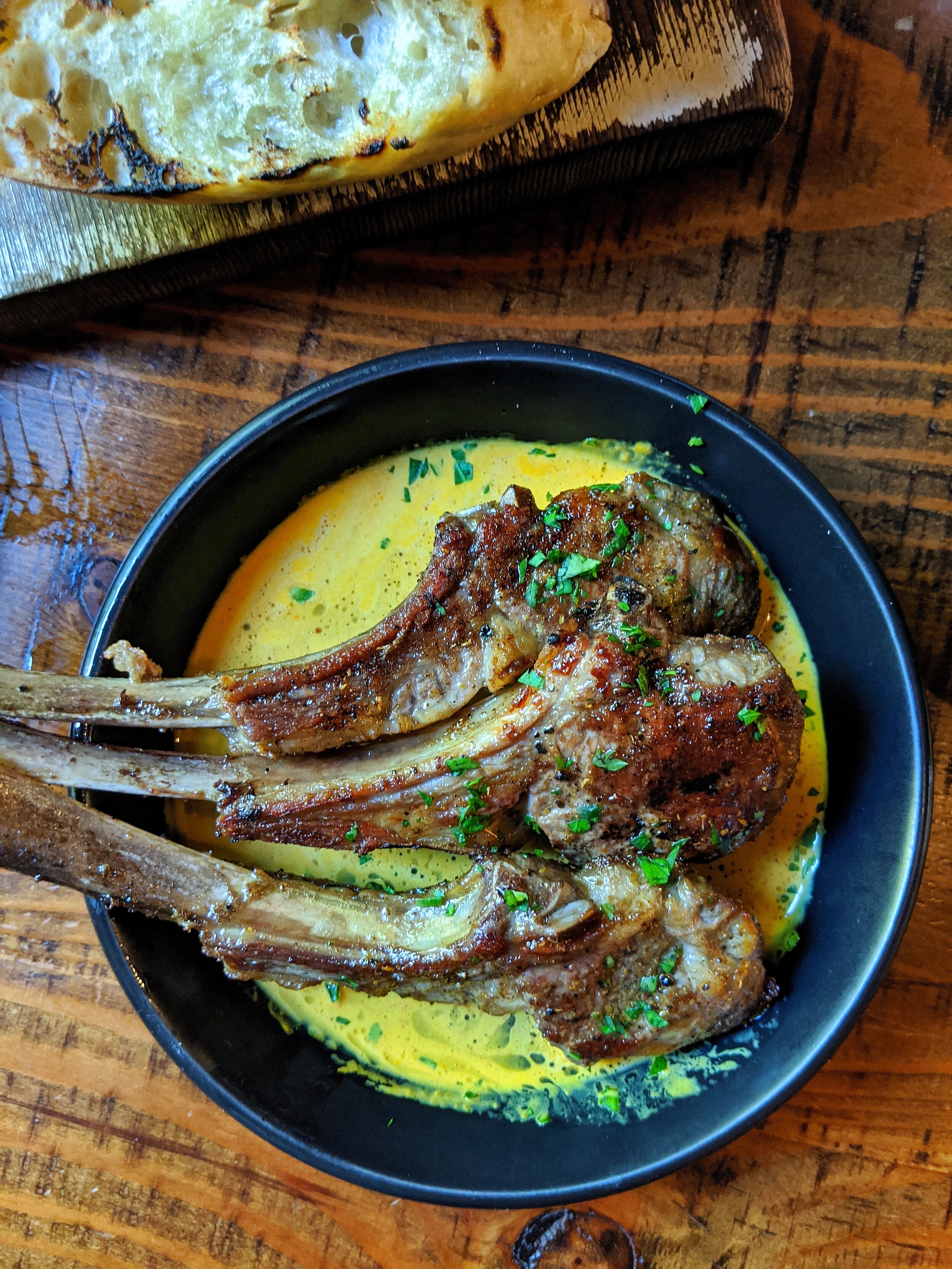 Lamb Popsicles - Ras al hanout seasoned lamb popsicles in a creamy coconut curry. Nice flavours. Each lamb chop is $7 so order more or less.