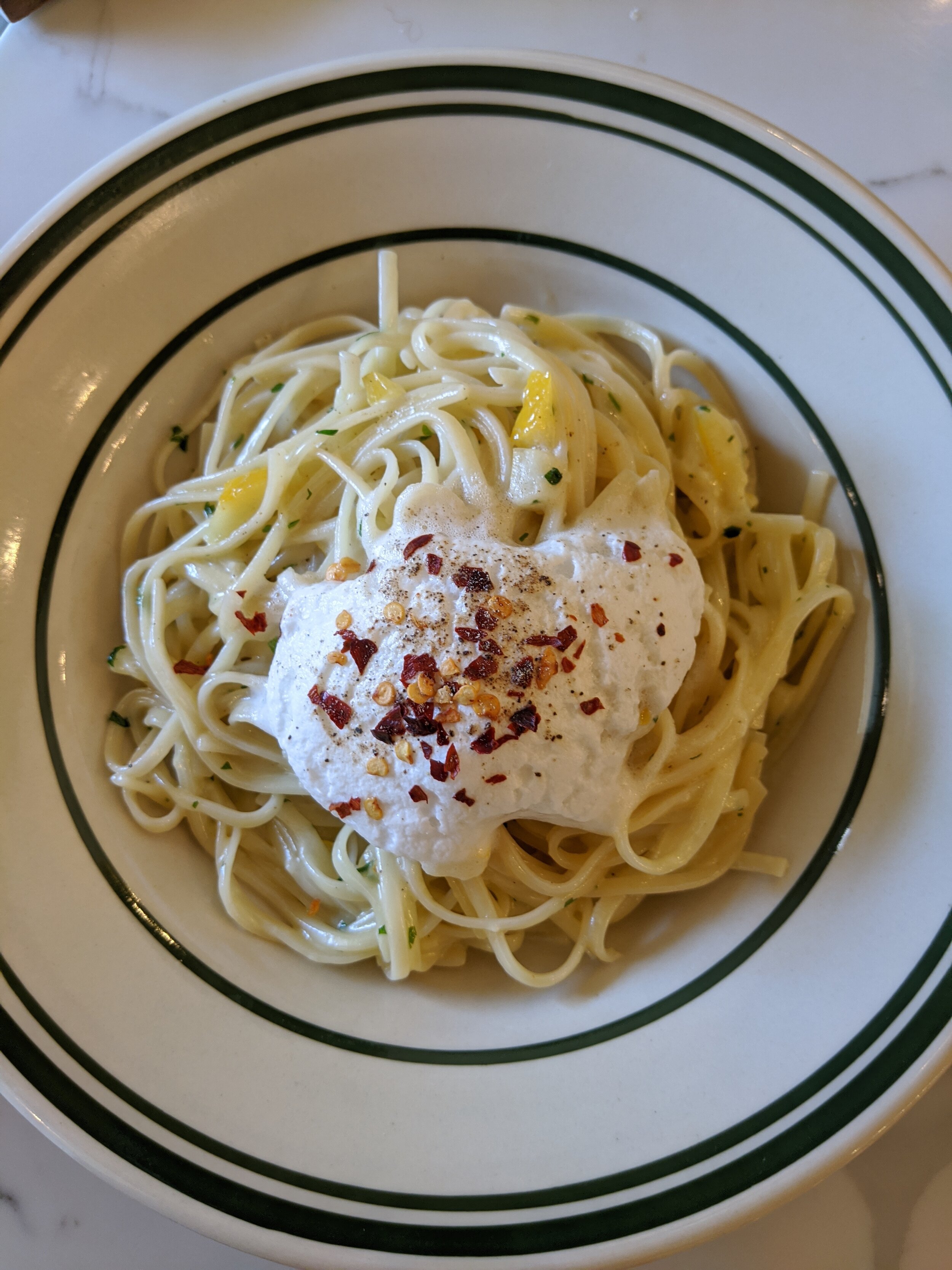 Linguine with preserved lemon,  cream, parmesan espuma, black pepper and topped with chilli flakes. A simple dish that’s FULL of flavour.