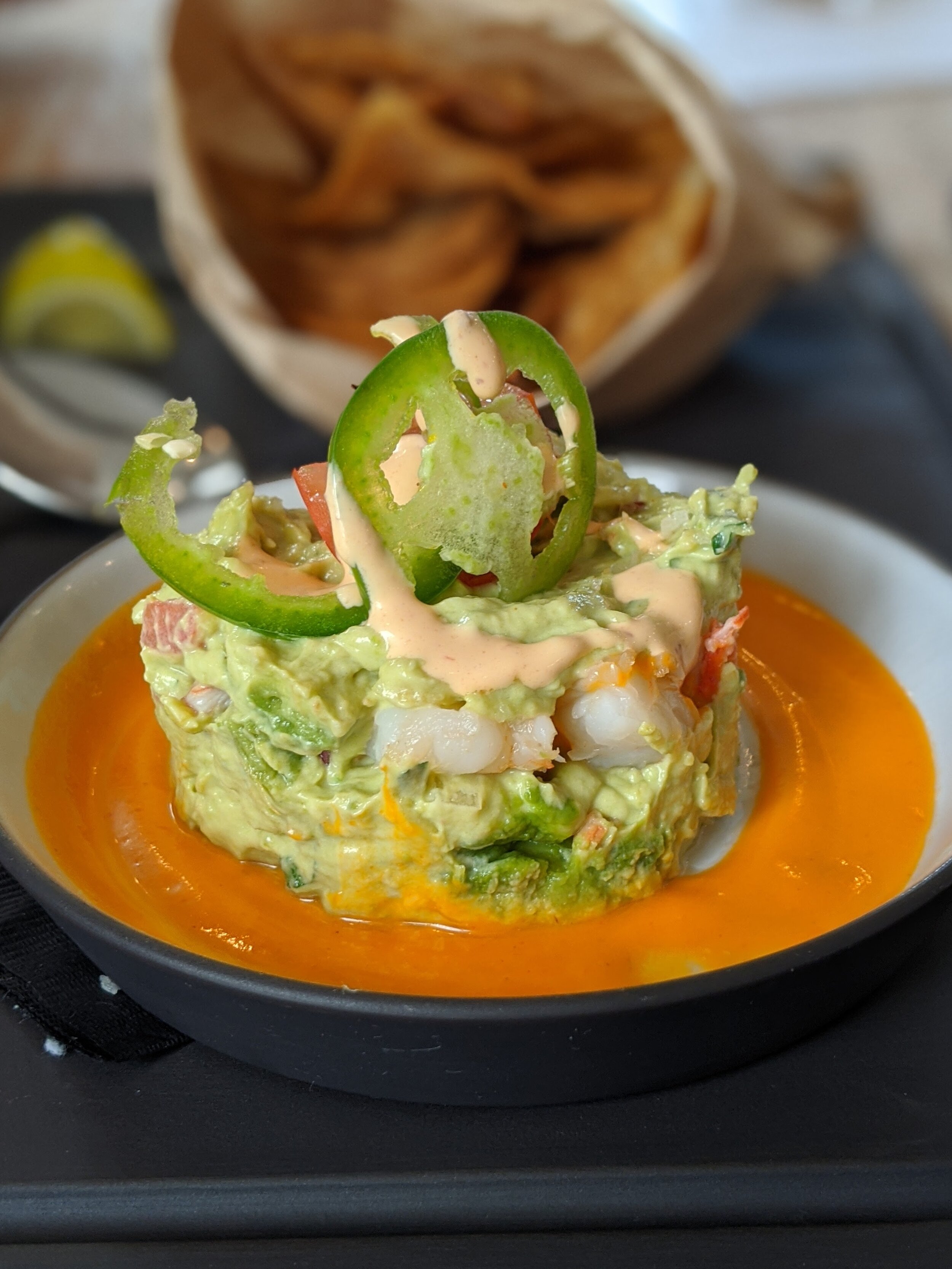 Guacamole with lobster, prawns, smoked tomato, spicy crema served with corn chip is next level.
